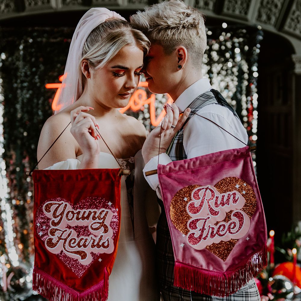 Deep pink and red velvet banners with retro font and glitter saying young hearts run free