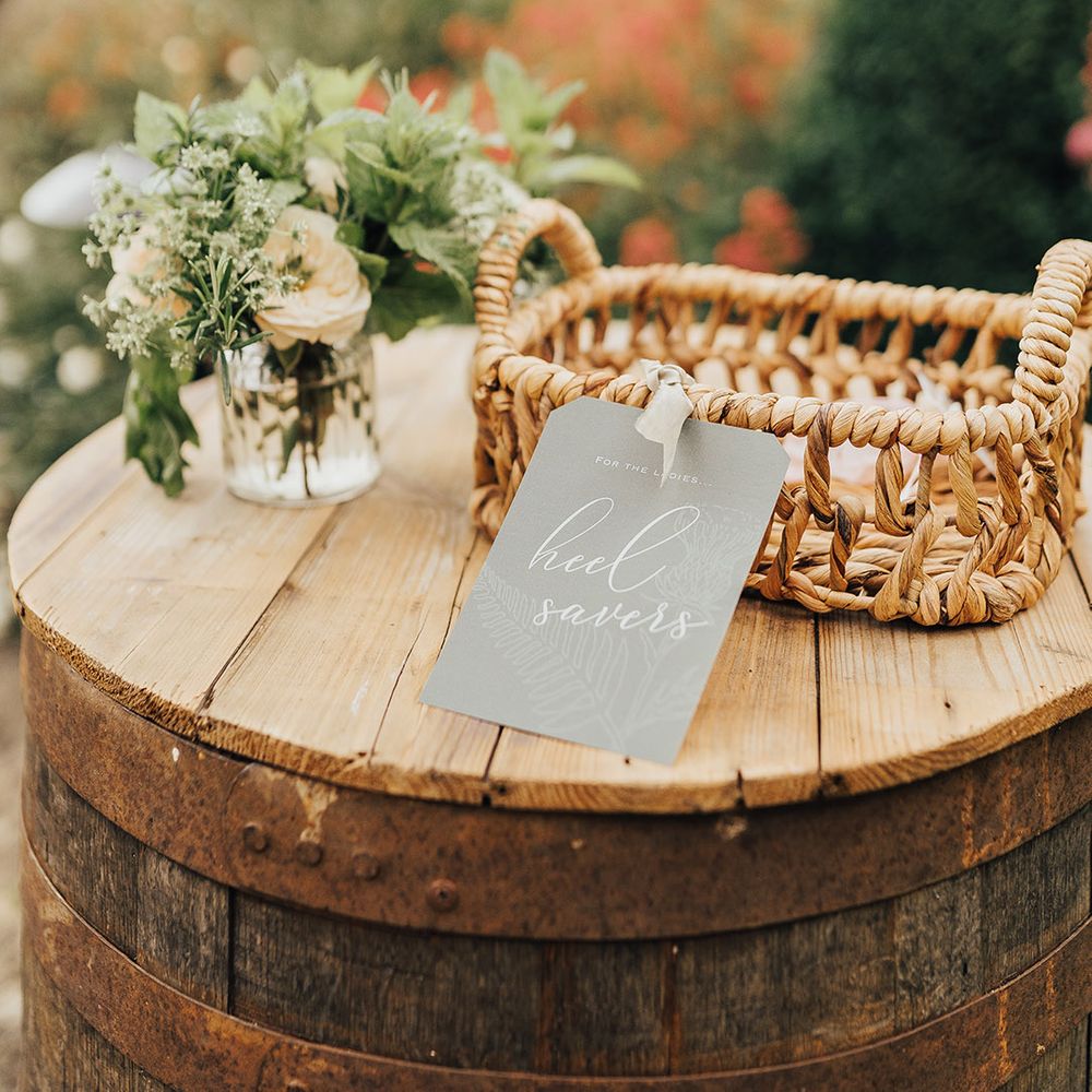 Wooden barrel and wicker basket with heel saves at luxury micro wedding 