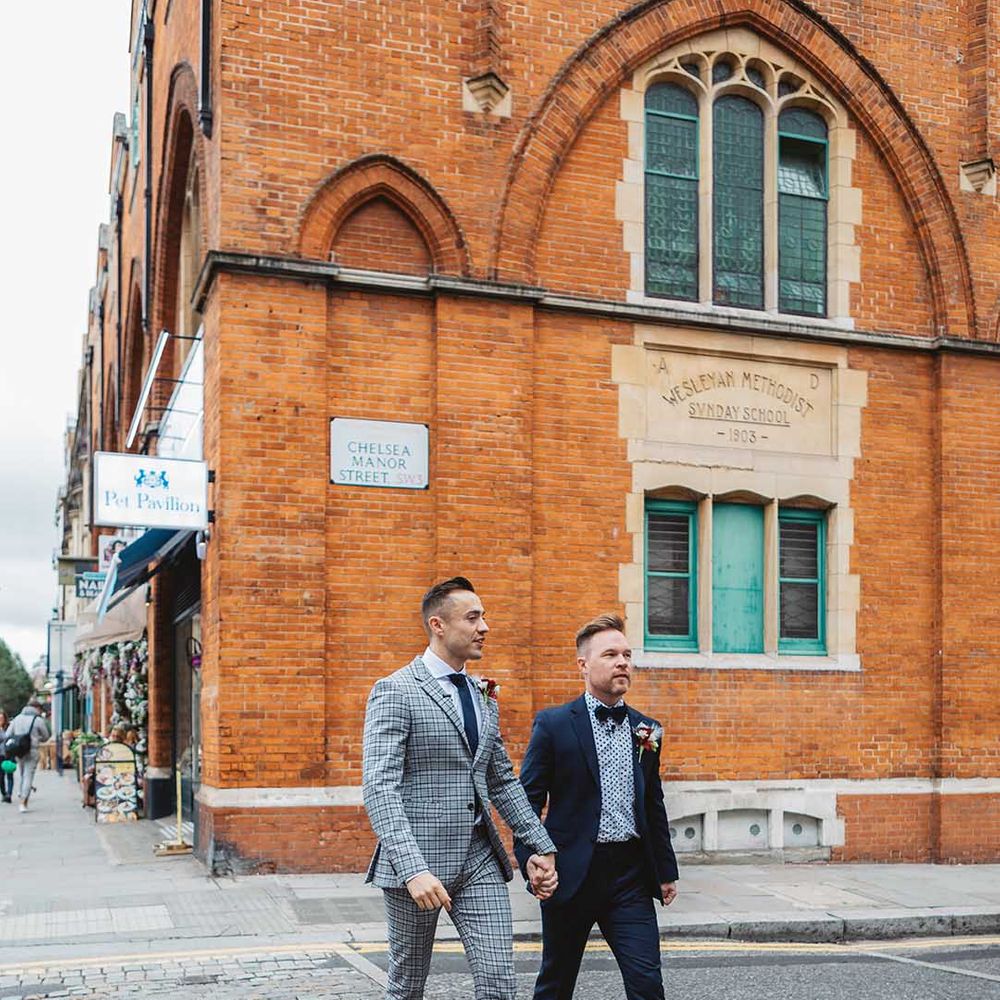 Grooms walk through Chelsea with one another on their wedding day