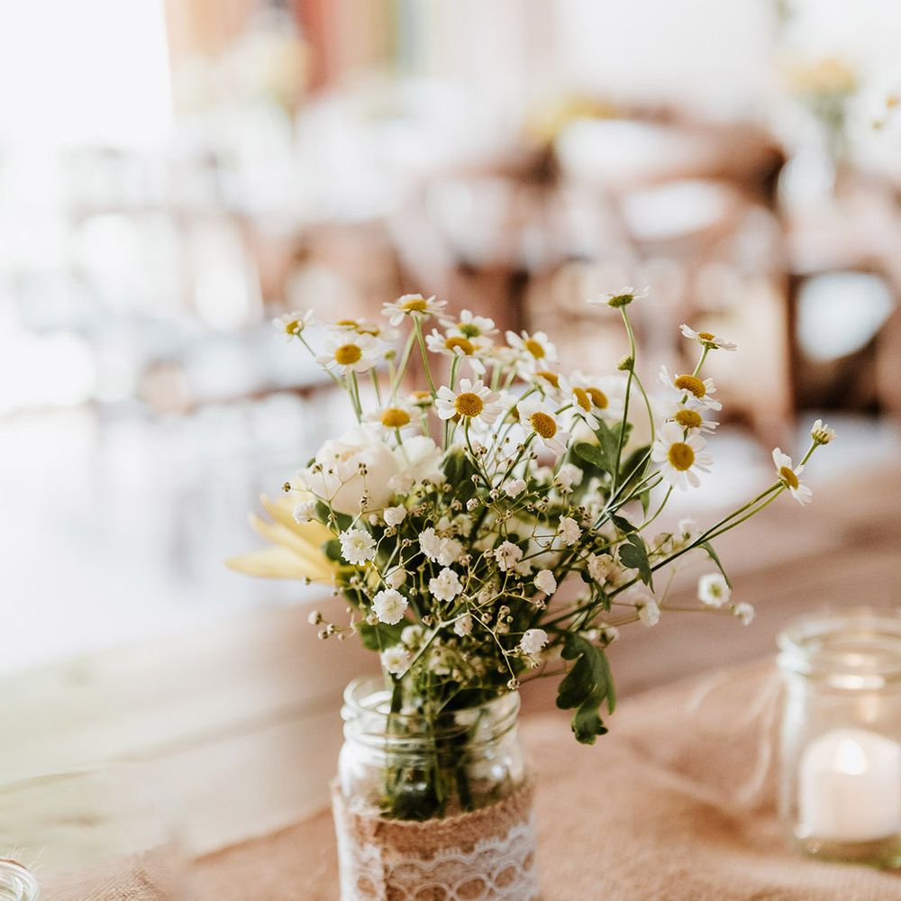 Small arrangement of gypsophila and daisies and other white flower for table decor