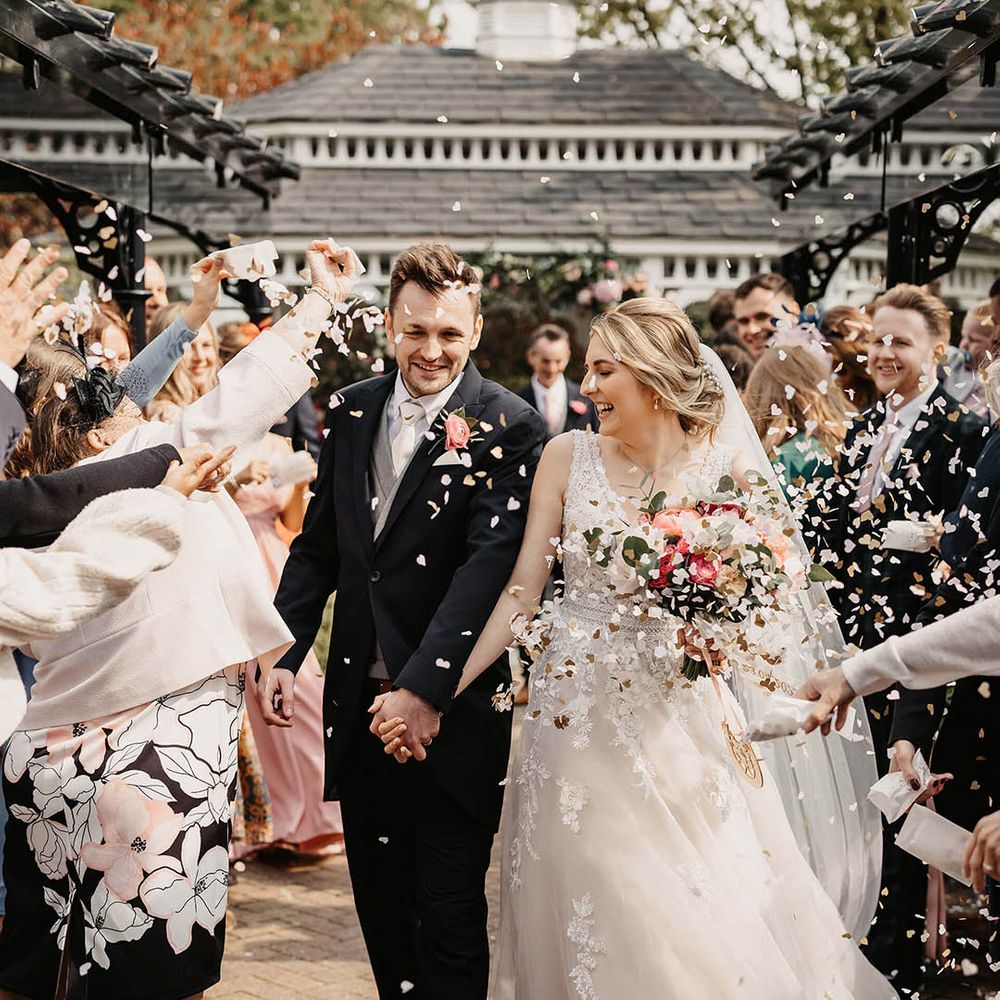 Bride and groom walk back down the aisle as a married couple 