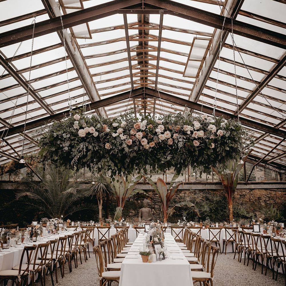 Glasshouse wedding venue with large wedding flower installation for South of France inspired wedding 