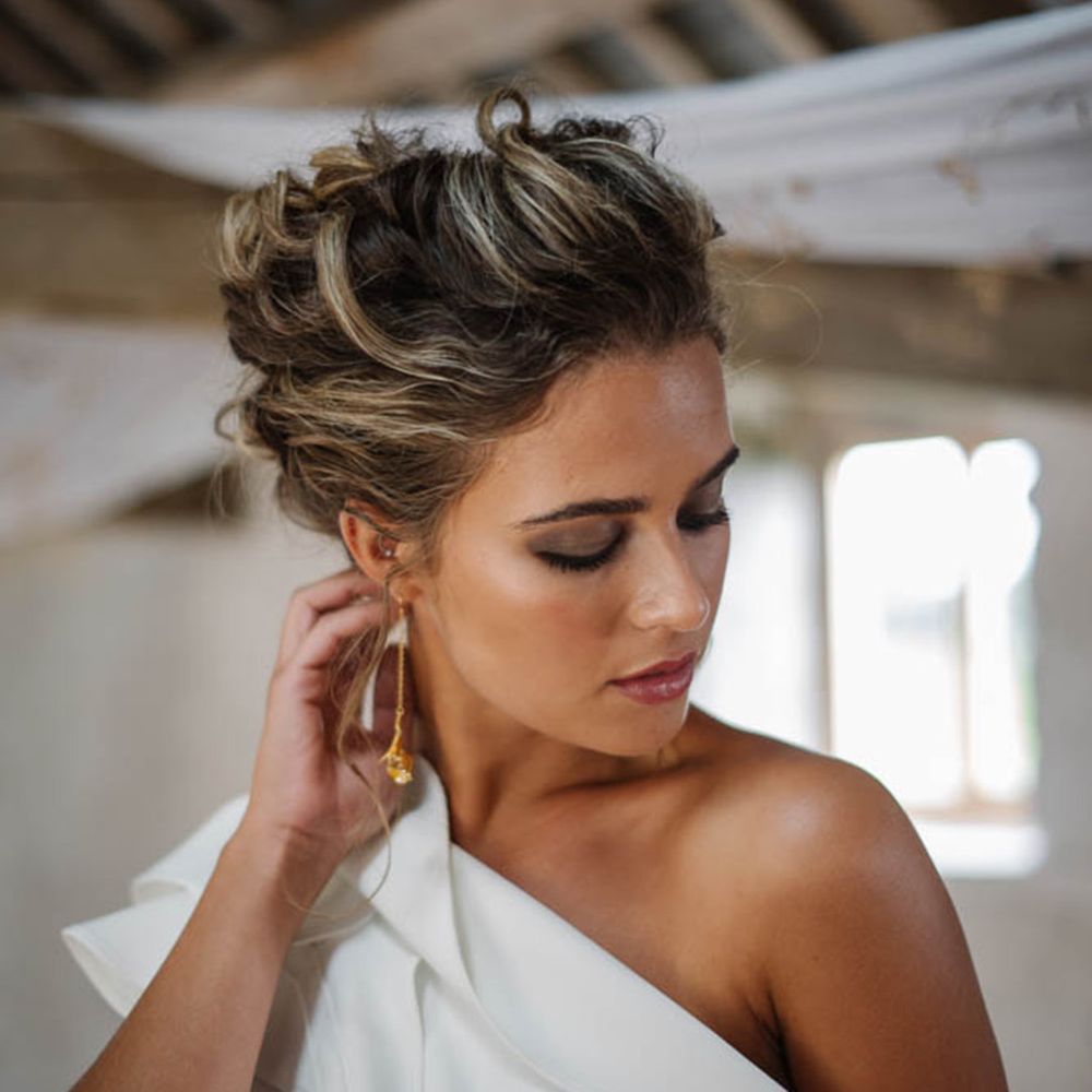 Bride in natural wedding makeup, bridal undo and dangly gold earrings 