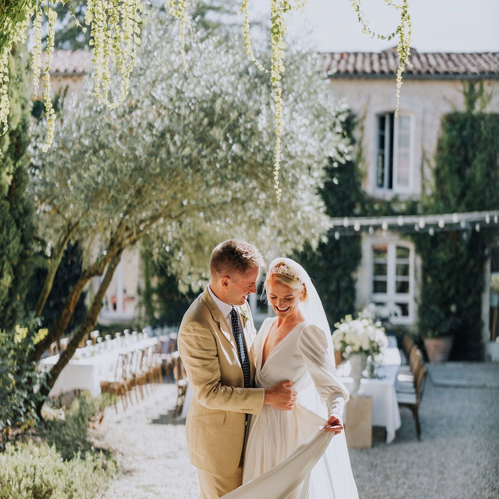 Château de Malliac French wedding venue with bride in a floaty destination wedding dress and groom in a light coloured suit