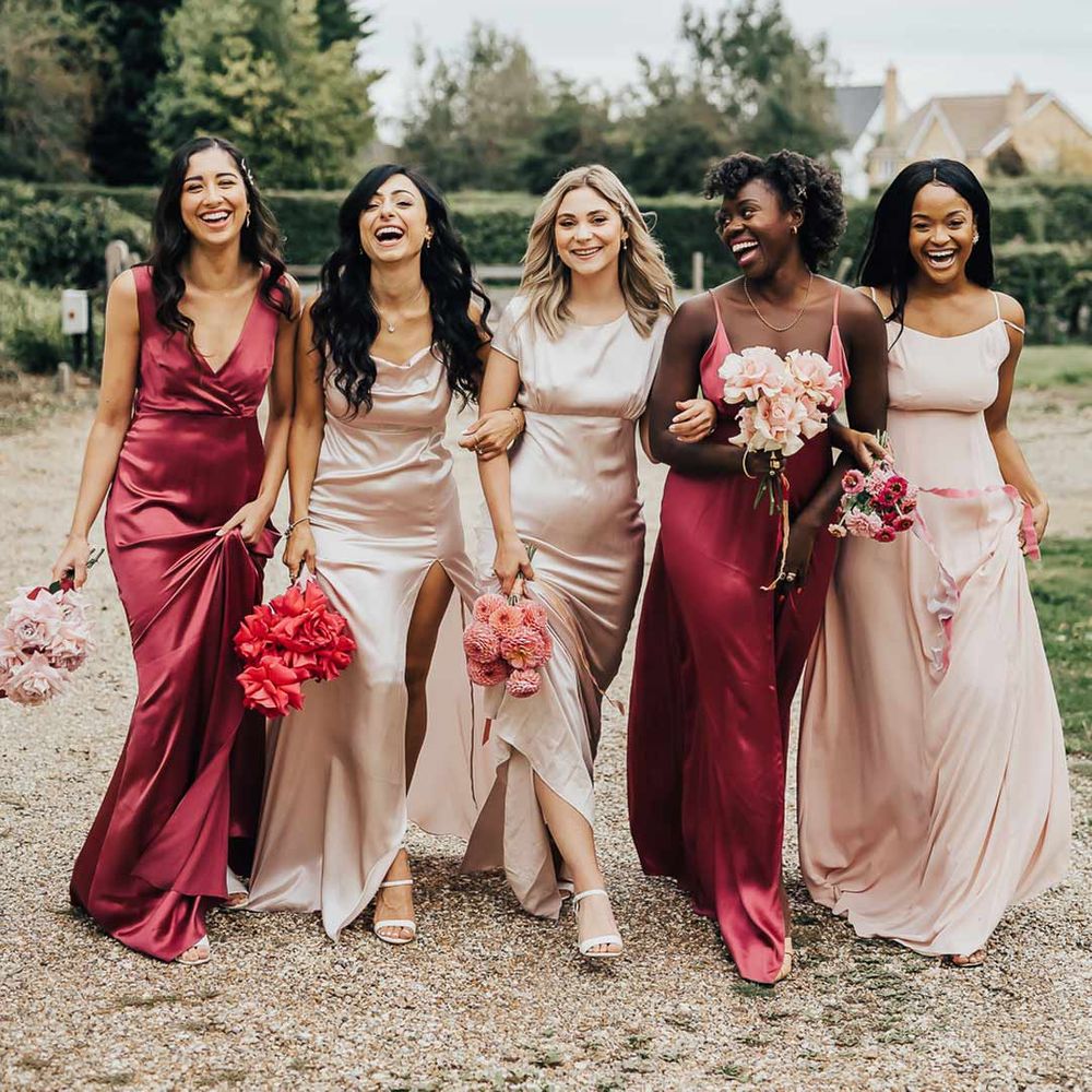 Bridesmaids wearing mismatched light and hot pink bridesmaid dresses for pink colour scheme wedding