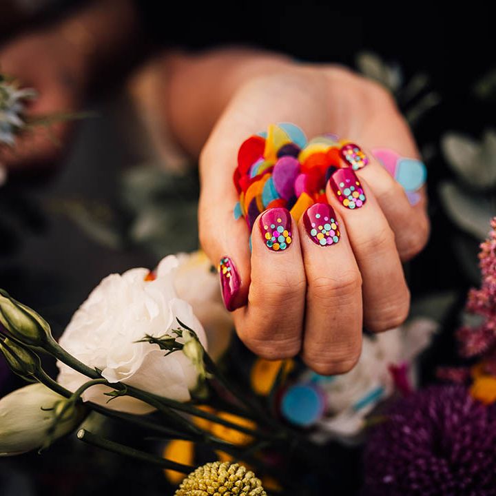 Bride with dark pink wedding nails with sparkly coloured sequins to match the bright wedding confetti 