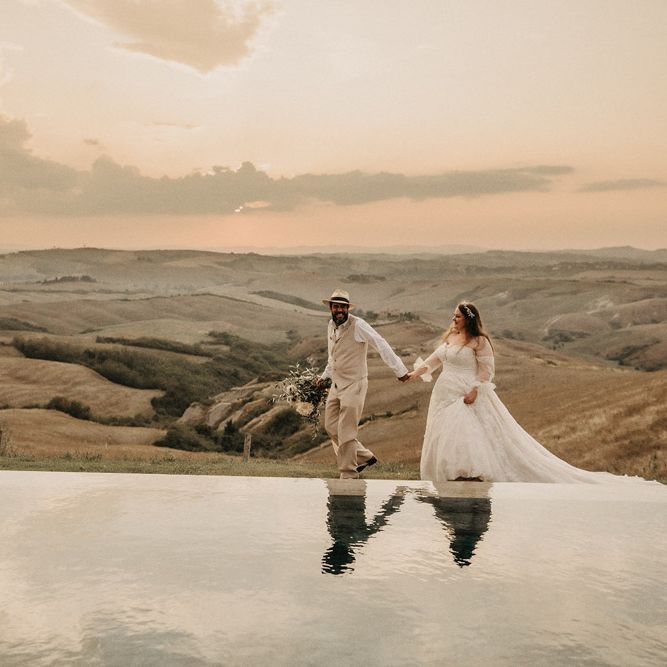 Bride and groom look over Tuscany olive groves