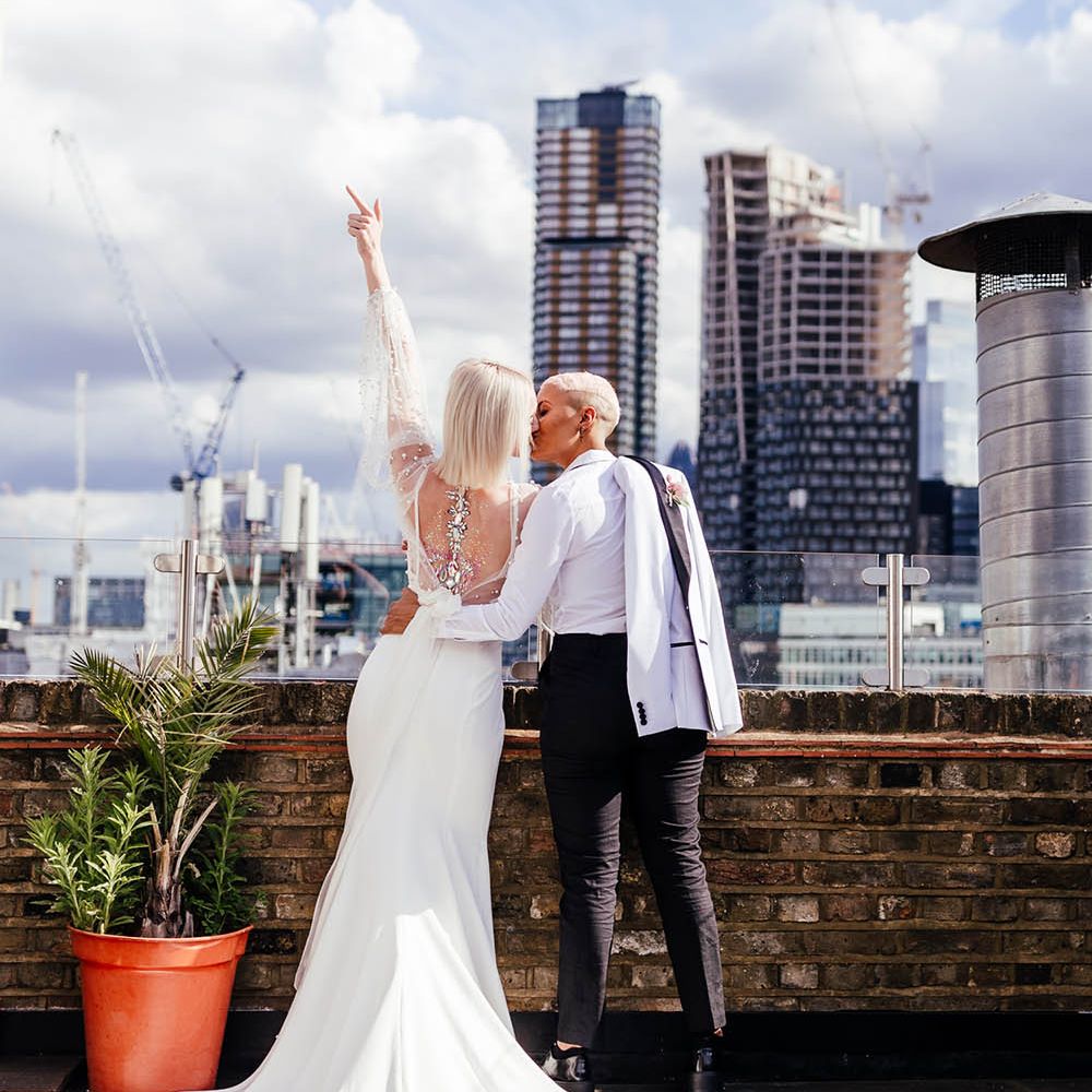 Bride in a low back wedding dress with gem body art 