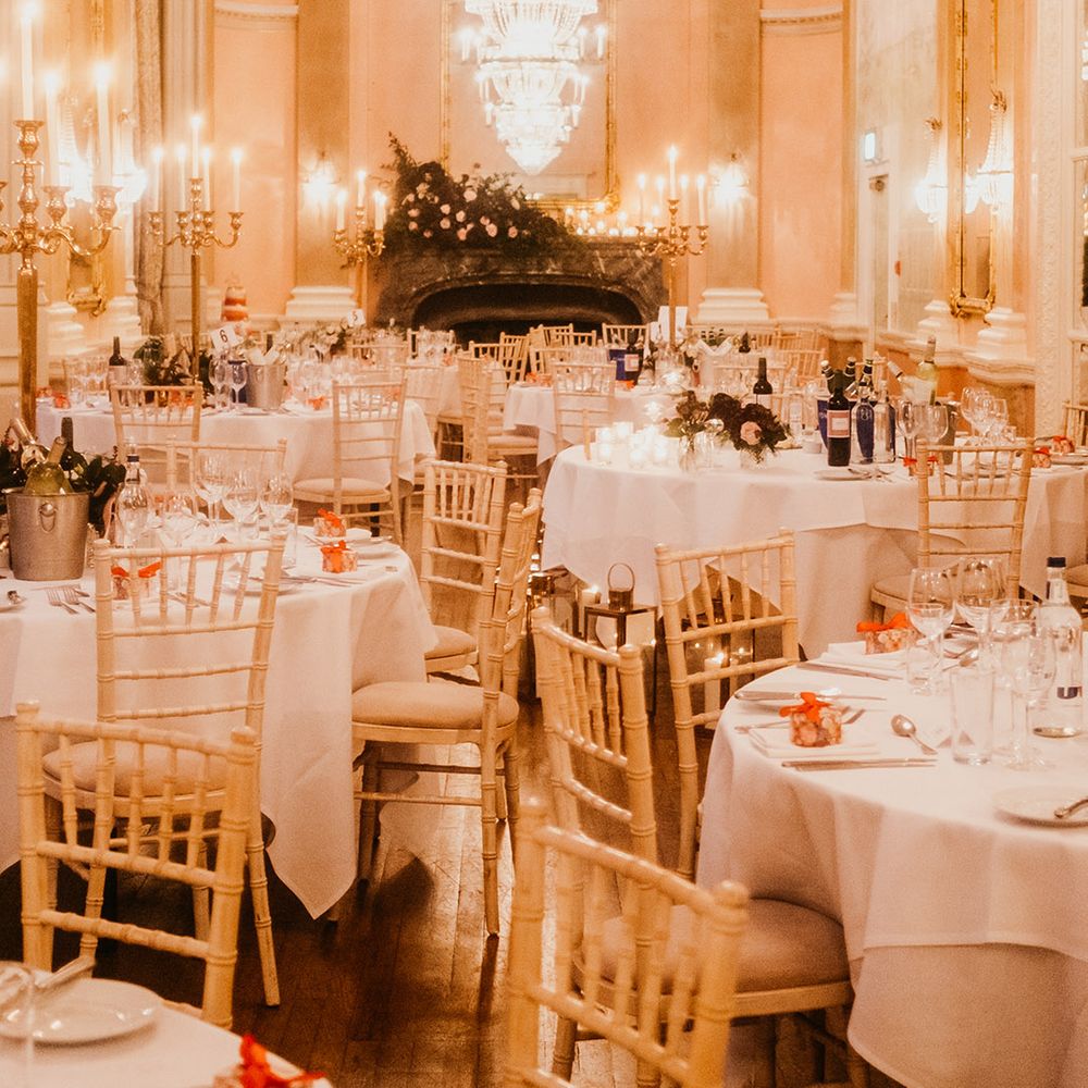 Crystal chandeliers hang over wedding tables at Danesfield House 