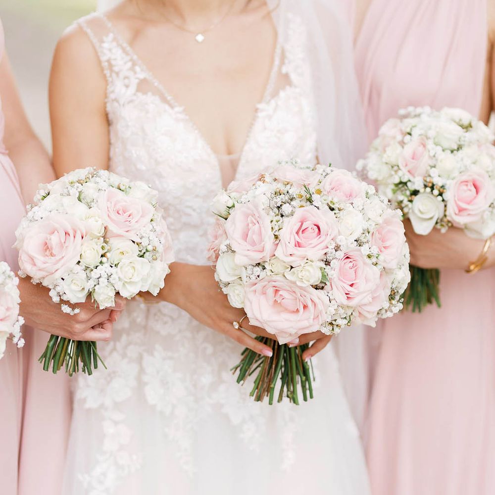 Bride & her bridesmaids hold floral bouquets