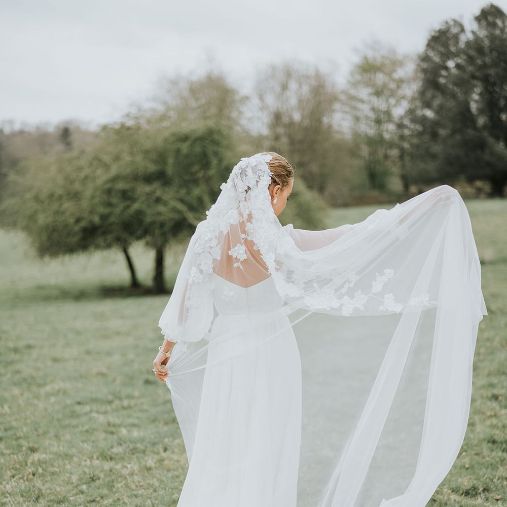 Bride wears a flower wedding veil of romantic wedding inspiration at Sezincote House