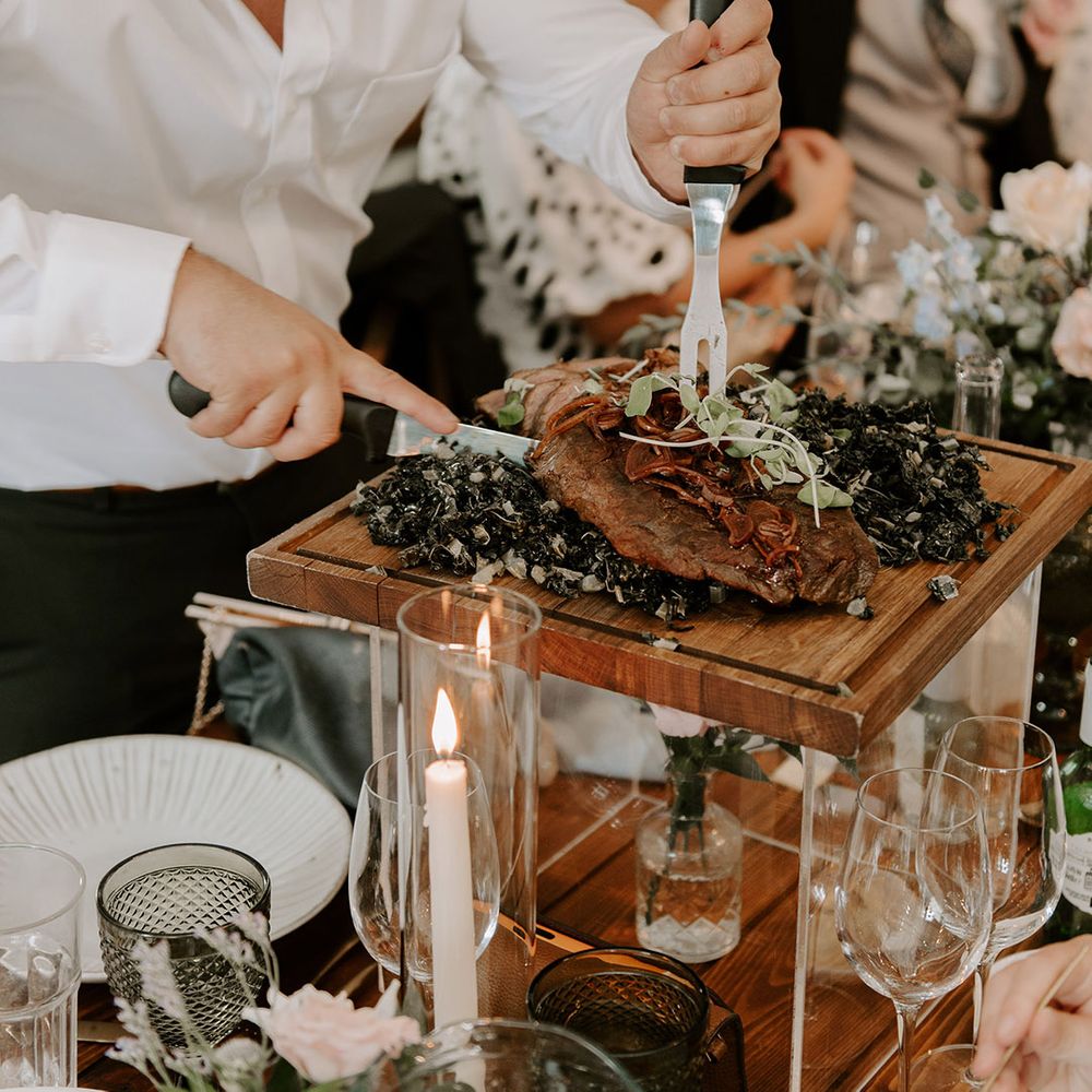 Chefs walk around the tables and carve the meat in front of the wedding guests 