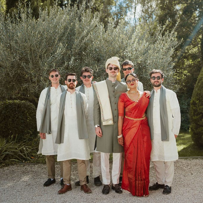 Bride in a red lehenga and groom in a green and cream Sherwani at destination Provence, Hindu wedding