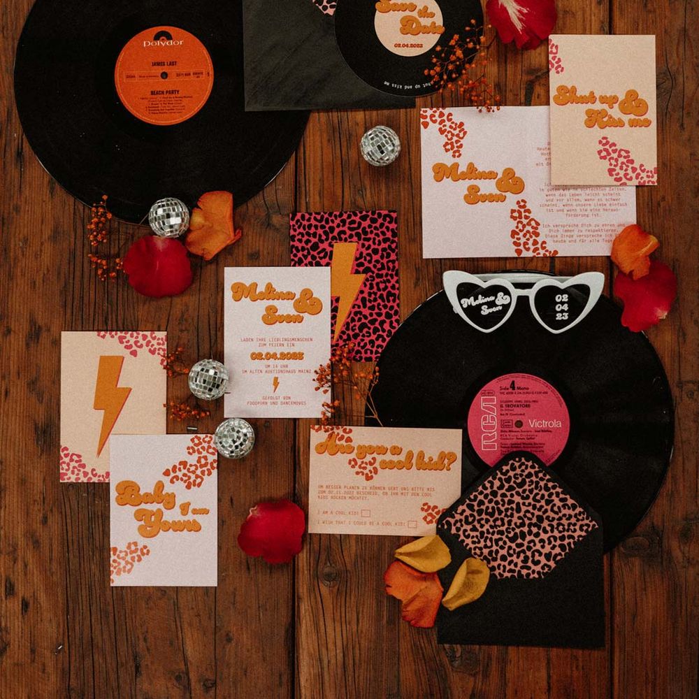 Retro wedding stationery and decor - vinyl wedding decor, disco ball decorations, heart shaped wedding sunglasses and leopard print wedding stationery