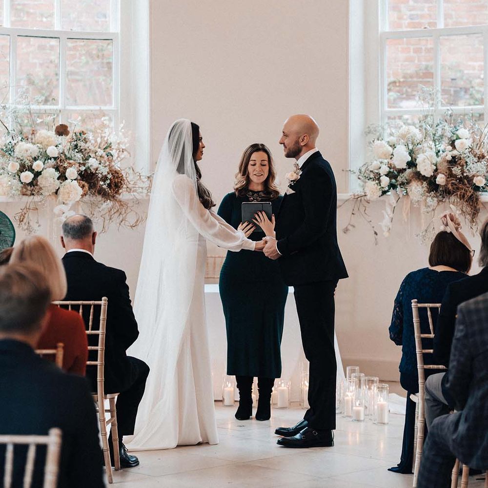 White ceremony room at Iscoyd Park is ideal for beautiful winter wedding days with white flower decor 