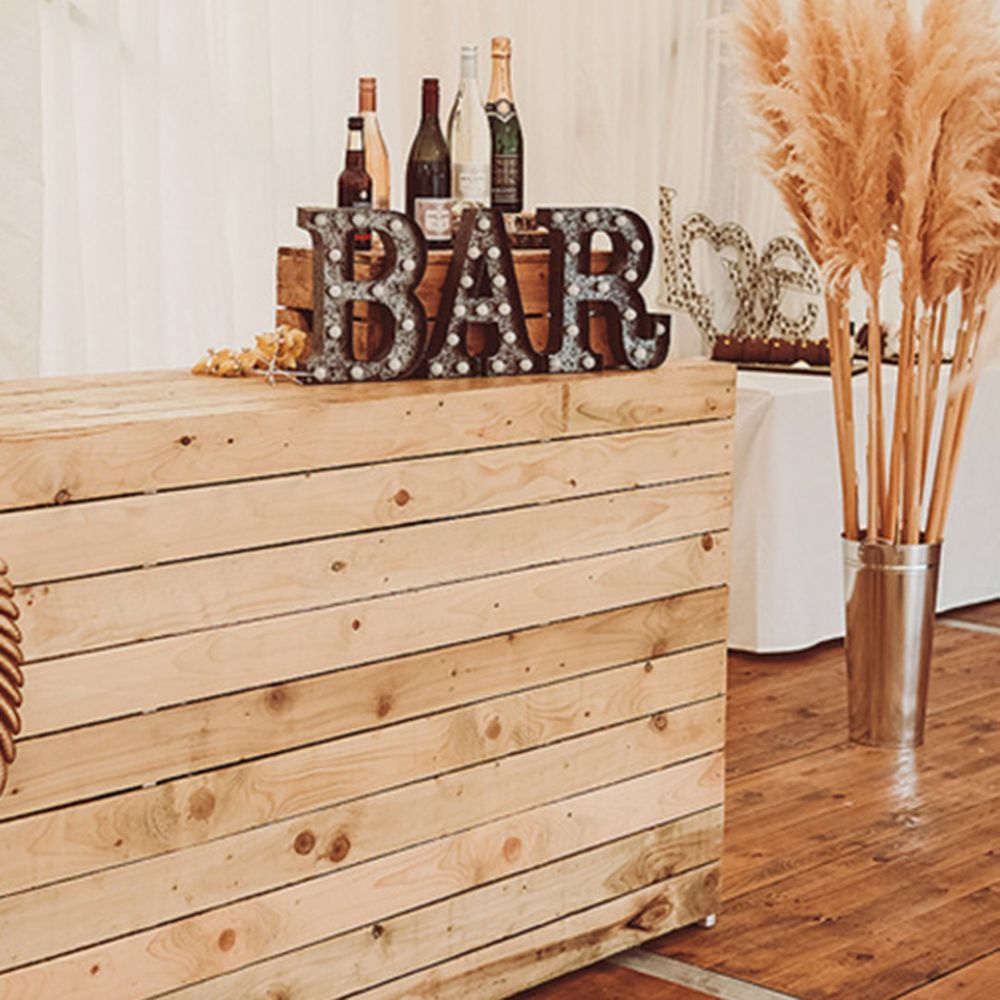 Marquee wedding bar design with rustic wedding signage and wooden crate 