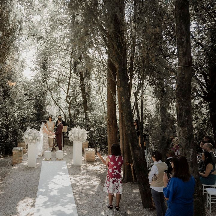 Luxe outdoor wedding ceremony in Italy with white wedding flowers 