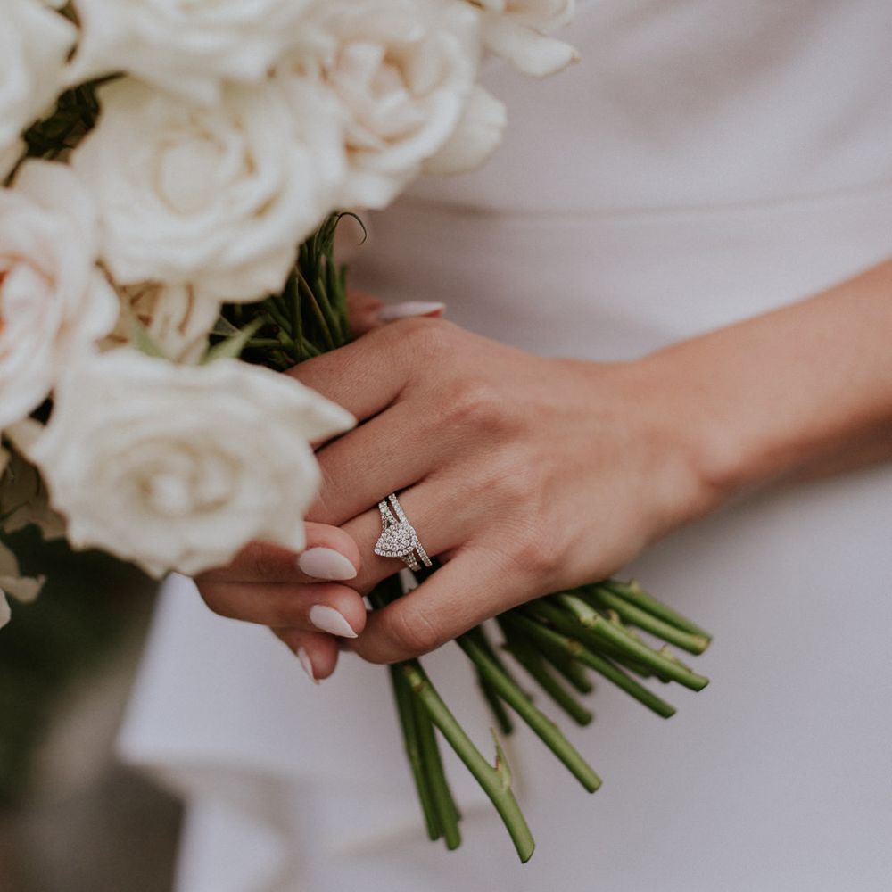 Diamond engagement ring and white rose bouquet 