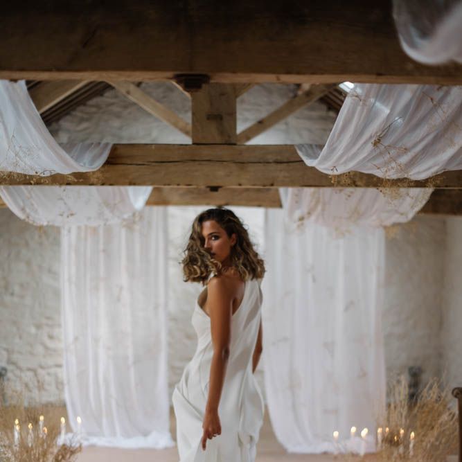 Bride in one shoulder trouser suit with train 