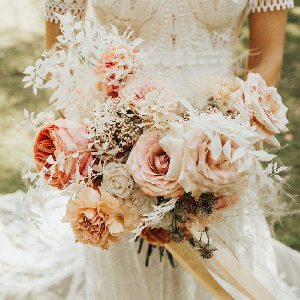 Bride holding pink and white rose bridal bouquet 