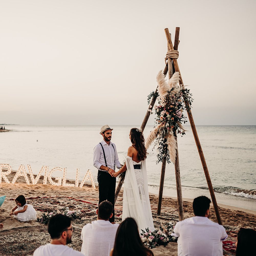 Beach wedding ceremony with naked tipi