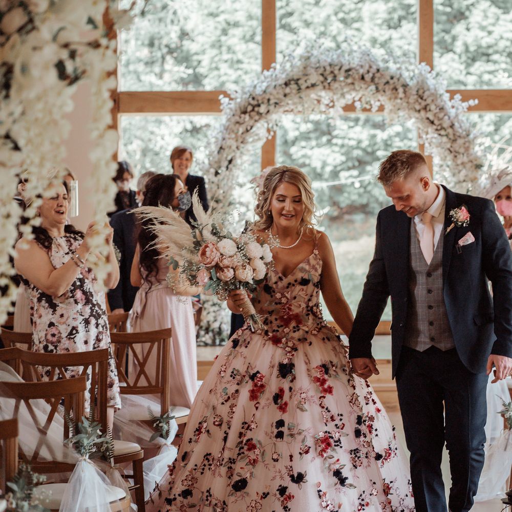 Bride & groom walk down the aisle after wedding ceremony