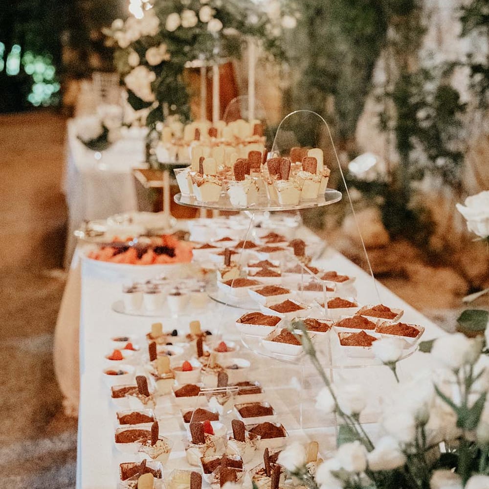 Table lined with white linen cloth filled with canapés  | Royal Studio