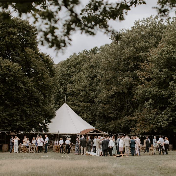 Tipi outdoors in field for woodland wedding