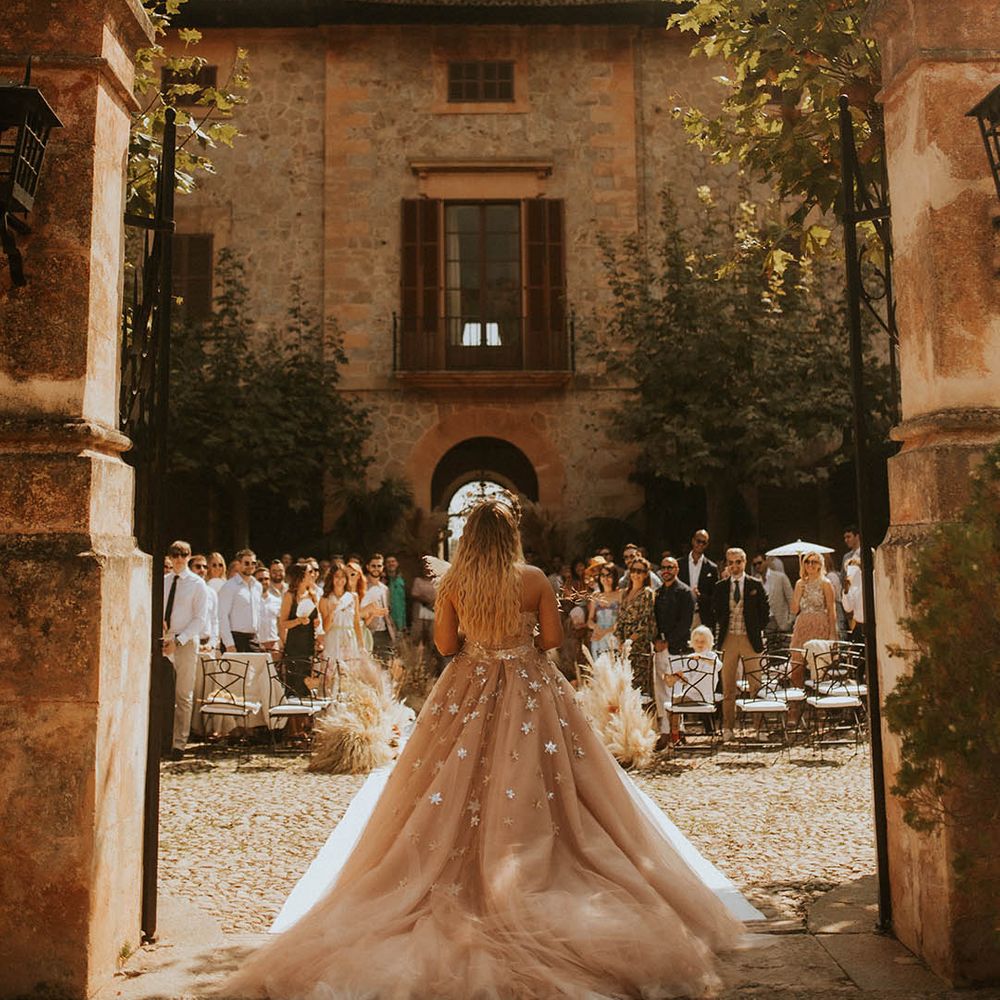 Bride walks into wedding ceremony wearing beautiful star gown