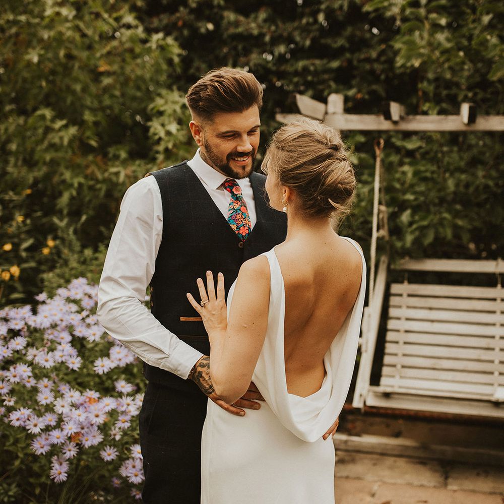 Charlie Brear cowl back wedding dress and pinned up do at back garden wedding