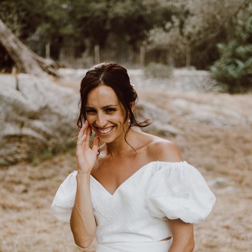 Smiling bride in Alexandra Grecco dress