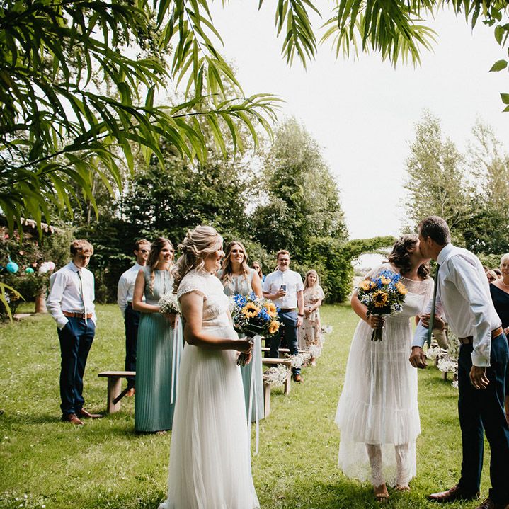 Bride kisses her father as he leaves her at the altar for outdoor wedding 