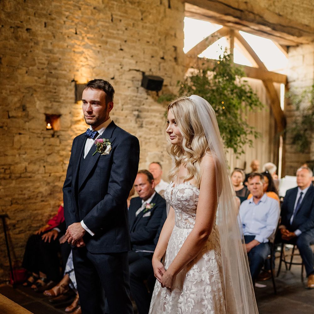 Bride and groom stand at the altar as they take part in their ceremony 