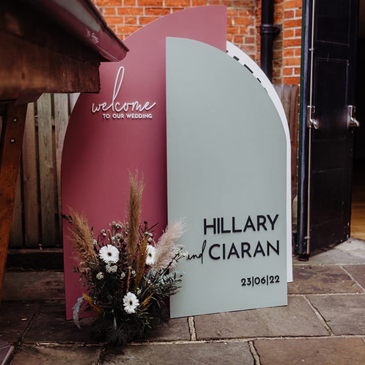 Pink and pale green welcome wedding sign with dried grasses 