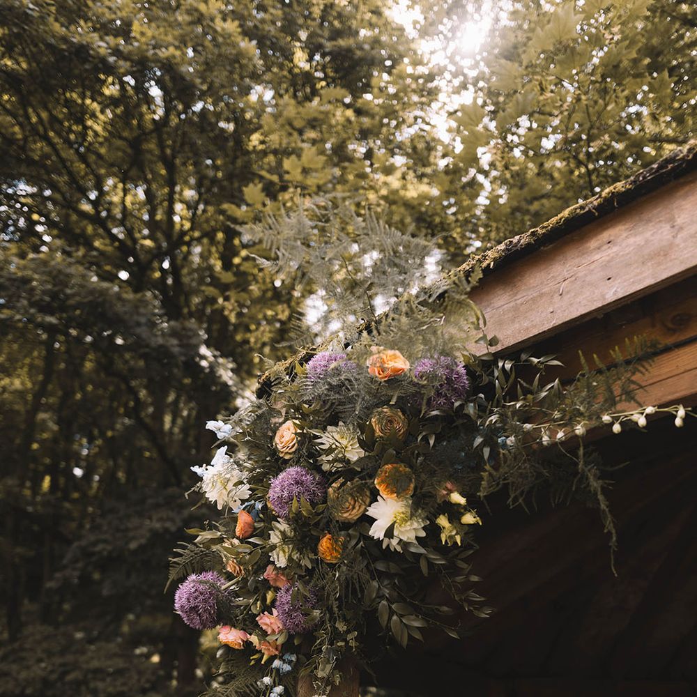 Orange and purple pastel wedding flower decorations for outdoor wedding at The Venue, Bowers Mill 