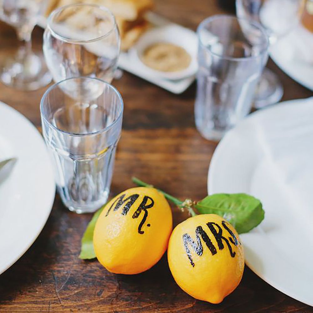 Wedding table decor with Mr and Mrs painted on lemons by Jonathan Ong Photography
