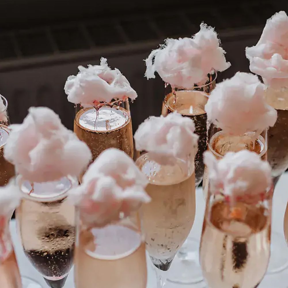 Rose-coloured prosecco with candy floss at the top by Cat Stephens Photography
