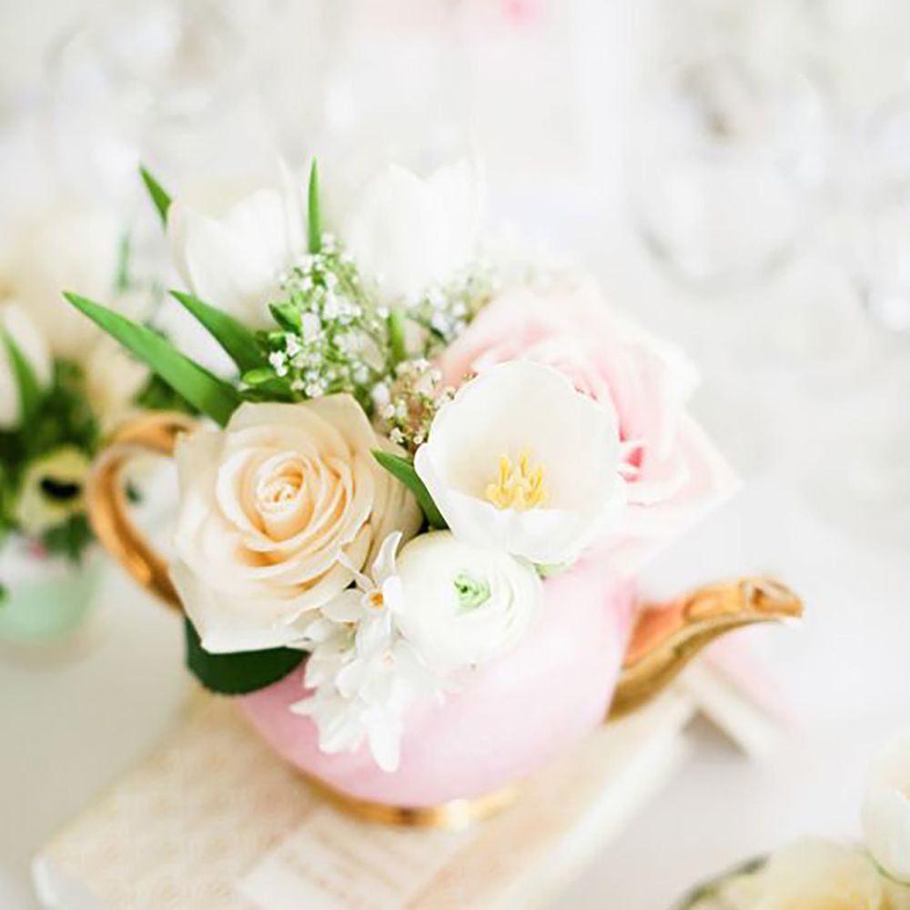 Pink teapot with flowers sitting inside by Dominique Bader Photography 