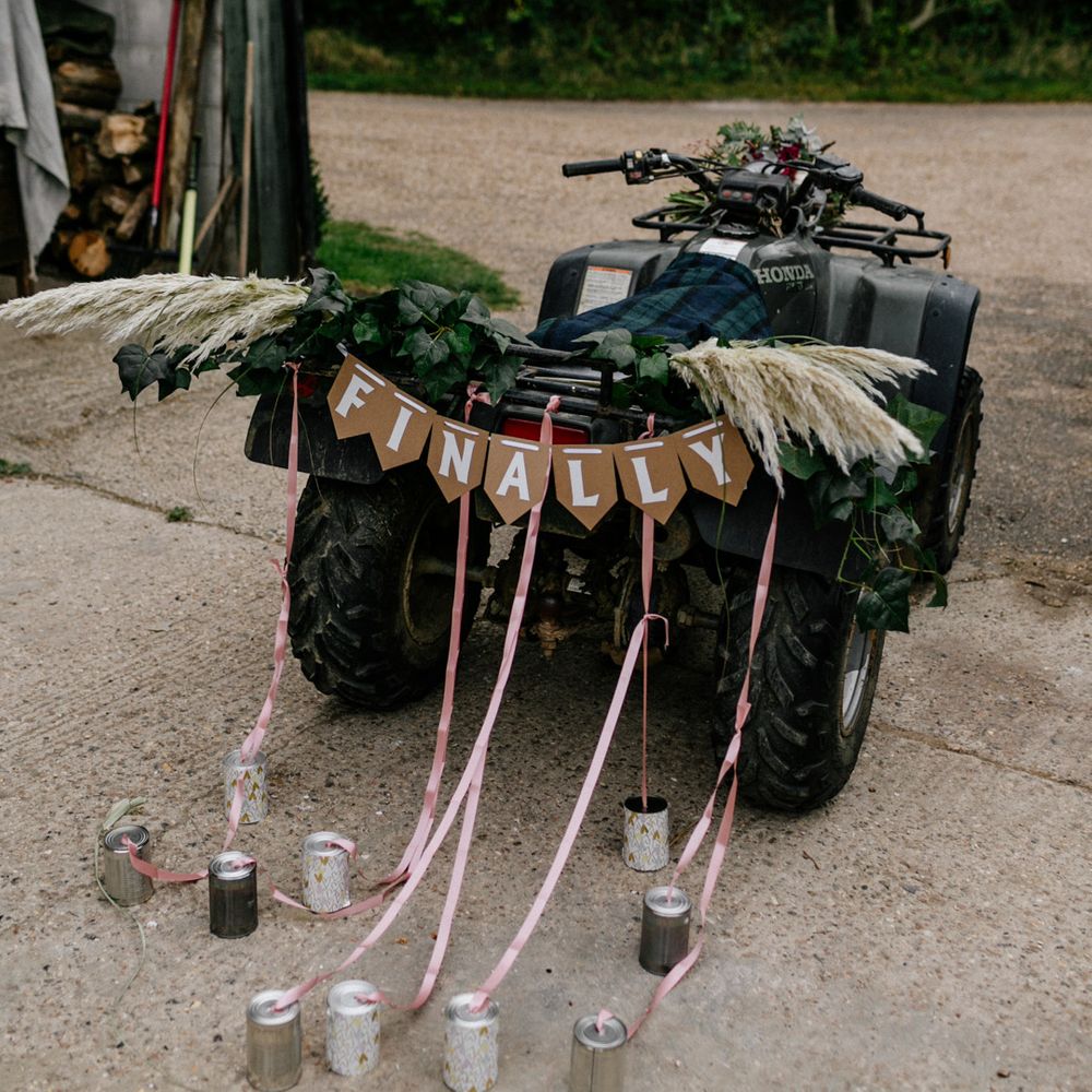 Quad bike with 'finally' bunting and tin can decor