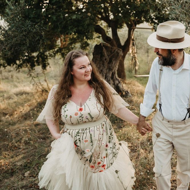 Bride wears floral embroidered wedding dress