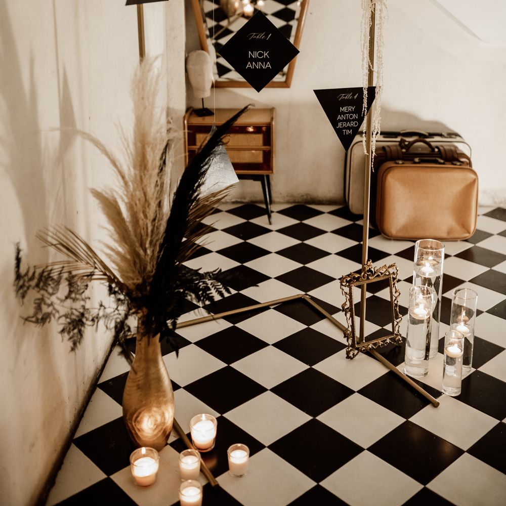 Black & white wedding decor with suspended table plan