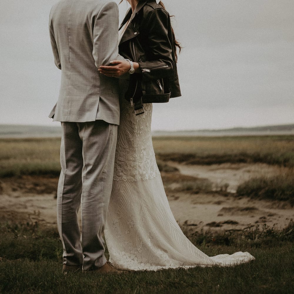 Bride in leather jacket wears a satin hair bow