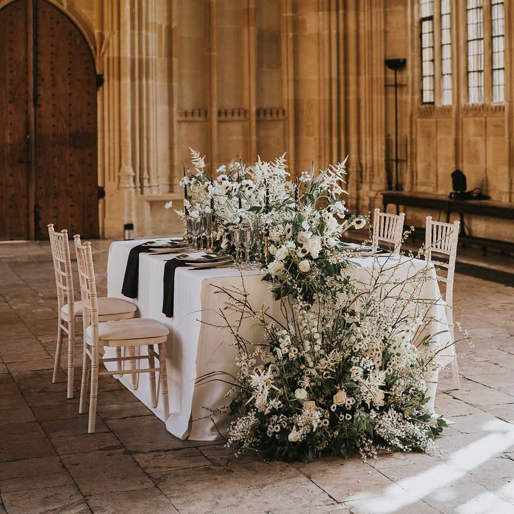 Monochrome tablescape at Bodleian with black and white flowers and table decor including roses 