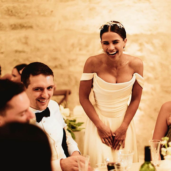 Bride laughs during wedding speeches