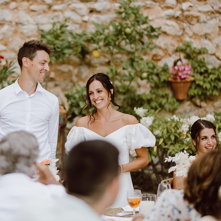 Bride and groom smile for speeches