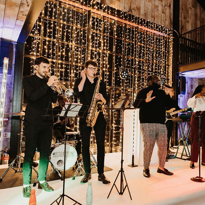 Live wedding band entertainment for winter wedding with fairy lights backdrop