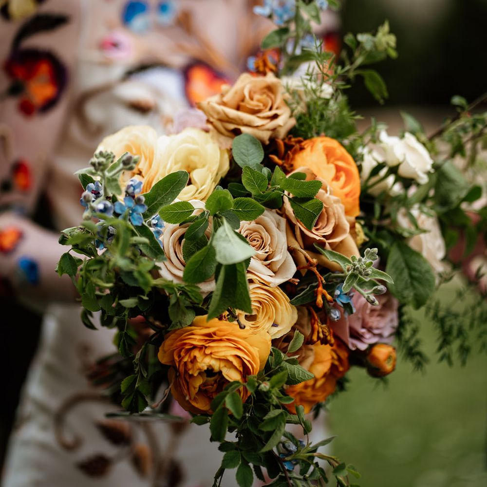 Orange, yellow, pink and blue wedding bouquet for colourful wedding 