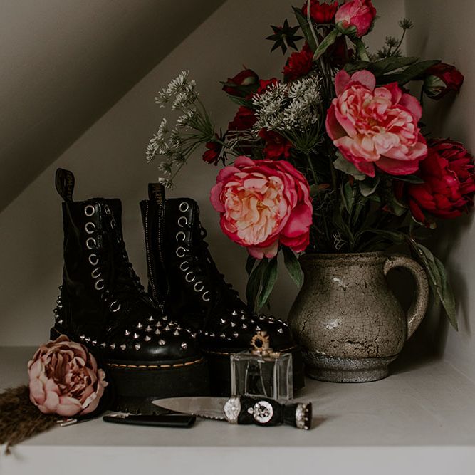 Dr Martens complete with platforms and studs next to flowers on wedding day 