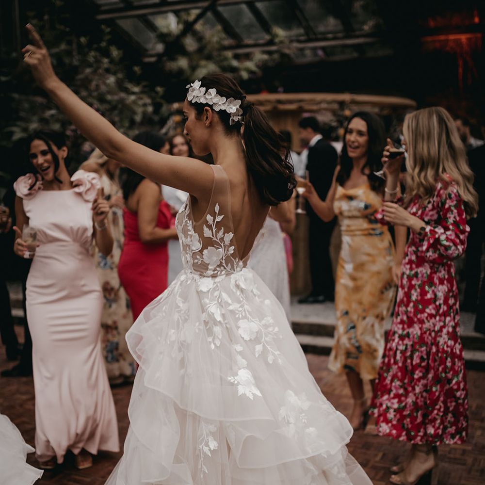 Bride in a low back illusion lace layered tulle wedding dress from Wtoo by Watters wedding dress 