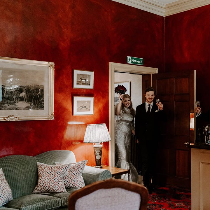 The bride and groom enter their wedding reception at Hambleton Hall in the East Midlands 